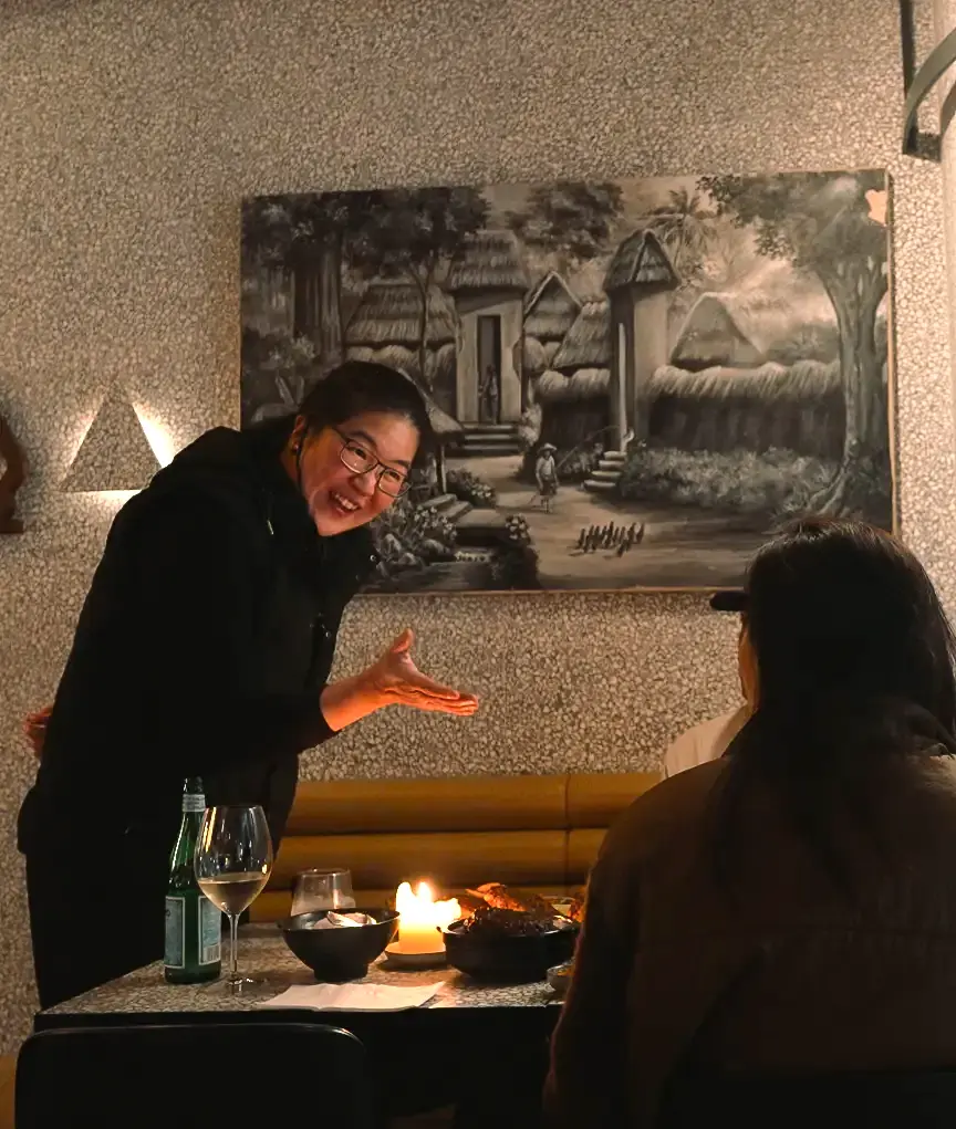 A KKO KKO host welcoming guests to their table